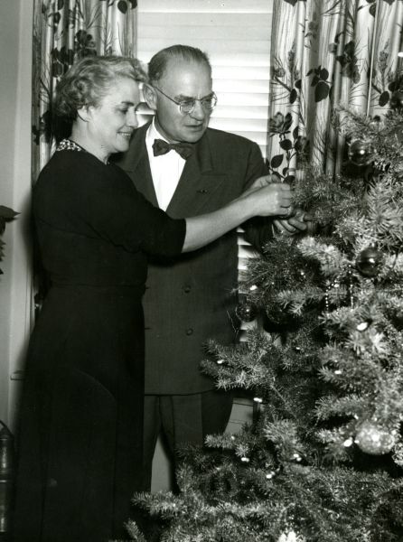 President and Mrs. Edman decorate the tree, 1954.